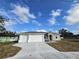 Newly constructed home with a three-car garage and a large yard at 2840 S Biscayne Dr, North Port, FL 34287