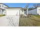 Single-story house with attached garage and landscaping at 3902 Radiant Mountain Dr, Plant City, FL 33565