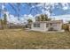 Home's backyard with screened porch and fenced yard at 3531 Oxford Dr, Holiday, FL 34691