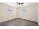 Bright bedroom with two windows and wood-look flooring at 3531 Oxford Dr, Holiday, FL 34691