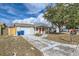 Front view of tan house with red door and driveway at 3531 Oxford Dr, Holiday, FL 34691