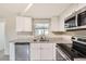 Bright kitchen with granite countertops and stainless steel appliances at 3531 Oxford Dr, Holiday, FL 34691