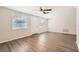 Living room with hardwood floors, windows, and ceiling fan at 3531 Oxford Dr, Holiday, FL 34691