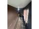 Narrow hallway with brown walls and vinyl flooring at 855 St Francis St, Brooksville, FL 34601
