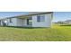 Home with covered patio and grassy backyard at 13859 Richland Gulf Cir, Parrish, FL 34219