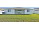 Spacious backyard with covered patio and grassy area at 13859 Richland Gulf Cir, Parrish, FL 34219