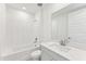 Clean bathroom with white tile and a vanity with quartz top at 13859 Richland Gulf Cir, Parrish, FL 34219