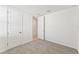Bright bedroom with carpet and double doors to hallway at 13859 Richland Gulf Cir, Parrish, FL 34219