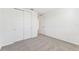 Bedroom with grey carpet, white walls and double doors to closet at 13859 Richland Gulf Cir, Parrish, FL 34219