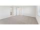 Well-lit bedroom with gray carpet and access to bathroom at 13859 Richland Gulf Cir, Parrish, FL 34219