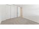 Bright bedroom with carpet, double doors and access to hallway at 13859 Richland Gulf Cir, Parrish, FL 34219