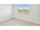 Bright bedroom with wood-look tile floor and view at 13859 Richland Gulf Cir, Parrish, FL 34219