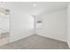 Simple bedroom with carpet, window, and access to hallway at 13859 Richland Gulf Cir, Parrish, FL 34219