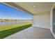 Covered patio overlooking a serene lake at 13859 Richland Gulf Cir, Parrish, FL 34219