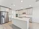 Modern kitchen with stainless steel appliances and light gray cabinets at 13859 Richland Gulf Cir, Parrish, FL 34219