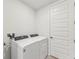 Laundry room with washer, dryer, and storage at 13859 Richland Gulf Cir, Parrish, FL 34219