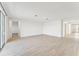 Open concept living area with light wood-look tile floors and access to other rooms at 13859 Richland Gulf Cir, Parrish, FL 34219