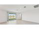 Bright living room with sliding glass doors leading to a view of a lake at 13859 Richland Gulf Cir, Parrish, FL 34219