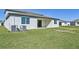 Home with covered patio and grassy backyard at 13868 Richland Gulf Cir, Parrish, FL 34219