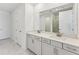 Elegant bathroom with double vanity and a large mirror at 13868 Richland Gulf Cir, Parrish, FL 34219
