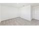 Simple bedroom with grey carpet and an interior door at 13868 Richland Gulf Cir, Parrish, FL 34219