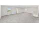 Spacious bedroom with grey carpet and access to a hallway at 13868 Richland Gulf Cir, Parrish, FL 34219