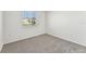Simple bedroom with carpeted floor and a window at 13868 Richland Gulf Cir, Parrish, FL 34219