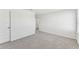 Well-lit bedroom with grey carpet and an adjacent room at 13868 Richland Gulf Cir, Parrish, FL 34219