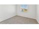 Bright bedroom with carpet flooring and a window offering natural light at 13868 Richland Gulf Cir, Parrish, FL 34219