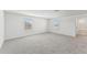 Large bedroom with grey carpet and two windows at 13868 Richland Gulf Cir, Parrish, FL 34219