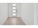 Bright entryway with light wood-look flooring and a modern door at 13868 Richland Gulf Cir, Parrish, FL 34219