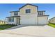 Two-story house with beige siding, blue shutters, and a three-car garage at 13868 Richland Gulf Cir, Parrish, FL 34219