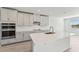 Modern kitchen with stainless steel appliances and an island at 13868 Richland Gulf Cir, Parrish, FL 34219