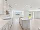 Modern kitchen with gray cabinets, white quartz countertops, and an island at 13868 Richland Gulf Cir, Parrish, FL 34219