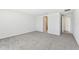 Main bedroom with carpet, access to bathroom and hallway at 13868 Richland Gulf Cir, Parrish, FL 34219