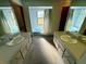 Clean bathroom with dual sinks, a bathtub, and light-blue tile at 12010 Villa Rd, Spring Hill, FL 34609