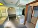 Bathroom with dual sinks, shower, and a view of another room at 12010 Villa Rd, Spring Hill, FL 34609