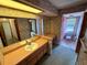 Bathroom with double vanity and pink floral wallpaper at 12010 Villa Rd, Spring Hill, FL 34609