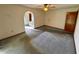 Bright bedroom featuring carpet floors and an arched doorway to the bathroom at 12010 Villa Rd, Spring Hill, FL 34609