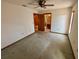 Large bedroom with carpet, ceiling fan and access to bathroom at 12010 Villa Rd, Spring Hill, FL 34609