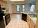 Kitchen with wood cabinets, black appliances, and a breakfast nook at 12010 Villa Rd, Spring Hill, FL 34609