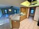 Bright kitchen features wood cabinets, a breakfast bar, and tile flooring at 12010 Villa Rd, Spring Hill, FL 34609
