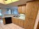 Kitchen with wood cabinets, black appliances, and double sink at 12010 Villa Rd, Spring Hill, FL 34609