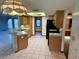 Kitchen boasts wood cabinets, black appliances, and a breakfast bar at 12010 Villa Rd, Spring Hill, FL 34609