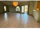 Bright living room with tile floors and a chandelier at 12010 Villa Rd, Spring Hill, FL 34609