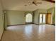 Spacious living room with tile floors and a view to the kitchen at 12010 Villa Rd, Spring Hill, FL 34609