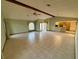Open living room with tile floors and high ceilings at 12010 Villa Rd, Spring Hill, FL 34609