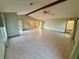 Large living room, tile floors, and access to backyard at 12010 Villa Rd, Spring Hill, FL 34609