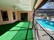 Inviting pool area with screened enclosure and grassy patio at 12010 Villa Rd, Spring Hill, FL 34609