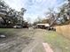Large backyard with mature trees, a shed, and a partially visible pool at 4935 Mockingbird Dr, Dade City, FL 33523